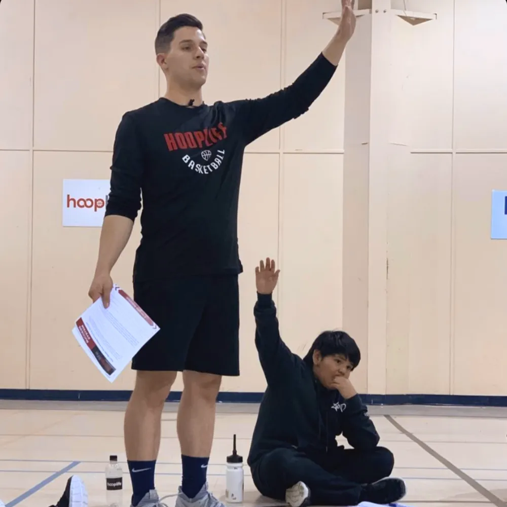Image of HoopLife's CEO Andrew Gottselig teaching kids at a nations clinic